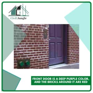 Front Door Is a Deep Purple Color, and the Bricks Around It Are Red